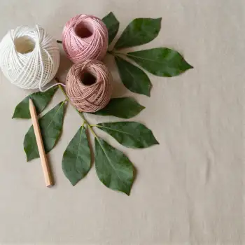 Three Colorful Yarn Balls Arranged on White Surface