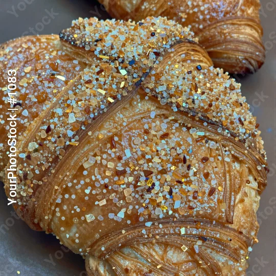 Freshly Baked Croissant with Colorful Sprinkles on Grey Plate