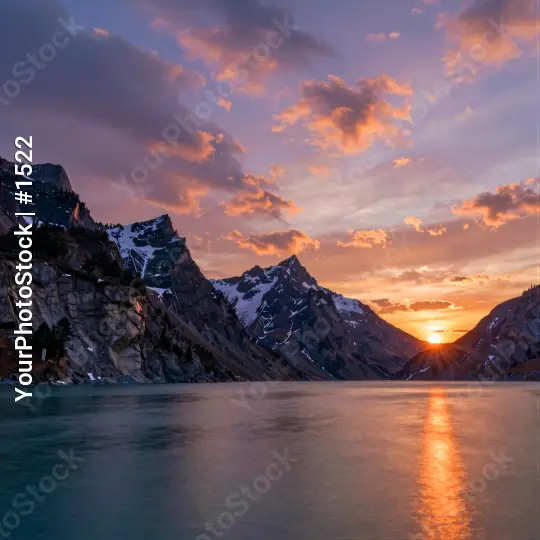 Mountain Range at Sunset with Snow-Capped Peaks