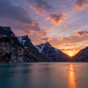 Mountain Range at Sunset with Snow-Capped Peaks