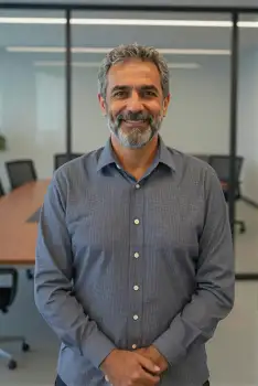 Middle-aged Man Smiling in Modern Office corporate branding