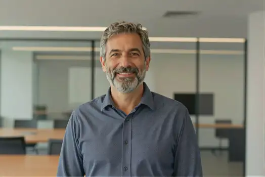 Middle-aged man smiling in office beard mustache