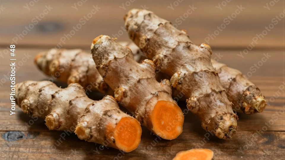Fresh Turmeric Roots on Wooden Surface organic