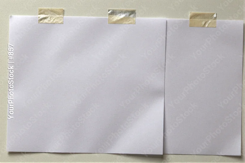 Two Crumpled White Sheets Hanging on Wall with Gold Tape sticky note