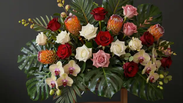 Vibrant Flower Arrangement in Wood Vase roses