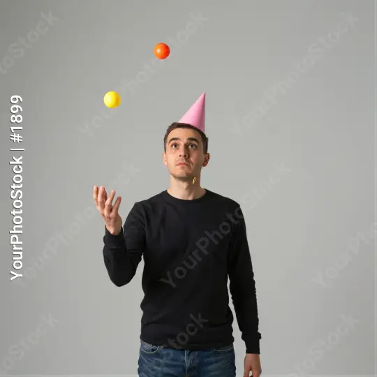 Young Man Catching Floating Balls Curiously curious expression