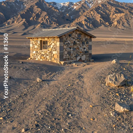 Desolate Stone Cabin in Barren Landscape mountains