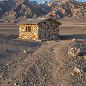 Desolate Stone Cabin in Barren Landscape mountains