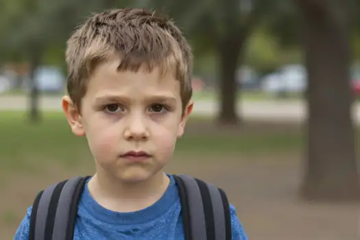 Young Boy in Park Looking Serious serious expression kid student