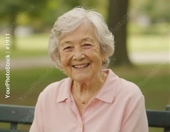 Happy Elderly Woman Smiling on Park Bench natural setting