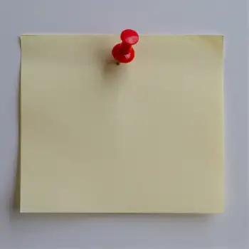 Blank Yellow Sticky Note on White Wall push pin