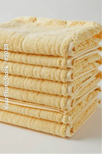 Neat Stack of Folded Yellow Towels floral pattern hotel