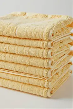 Neat Stack of Folded Yellow Towels floral pattern hotel