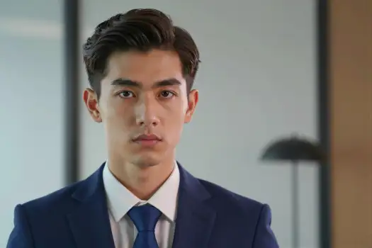 Young man in formal attire looking serious blue suit business