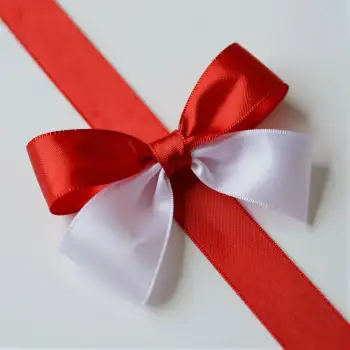 Red Ribbon with White Bow Close-Up neatly tied gift