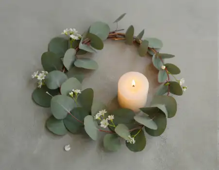 Eucalyptus Wreath with Lit Candle Flat Lay white flowers