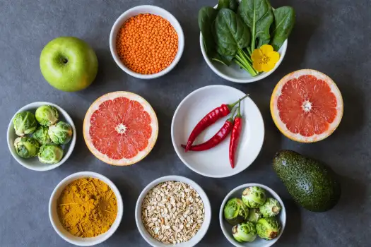 Circular Flat Lay of Fruits and Vegetables on Dark Grey Background