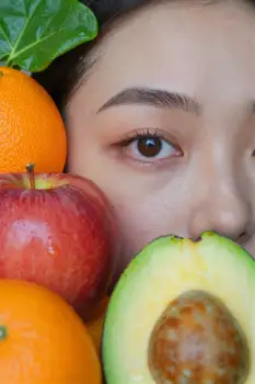 Young Woman Smiling with Fruits apple orange avocado