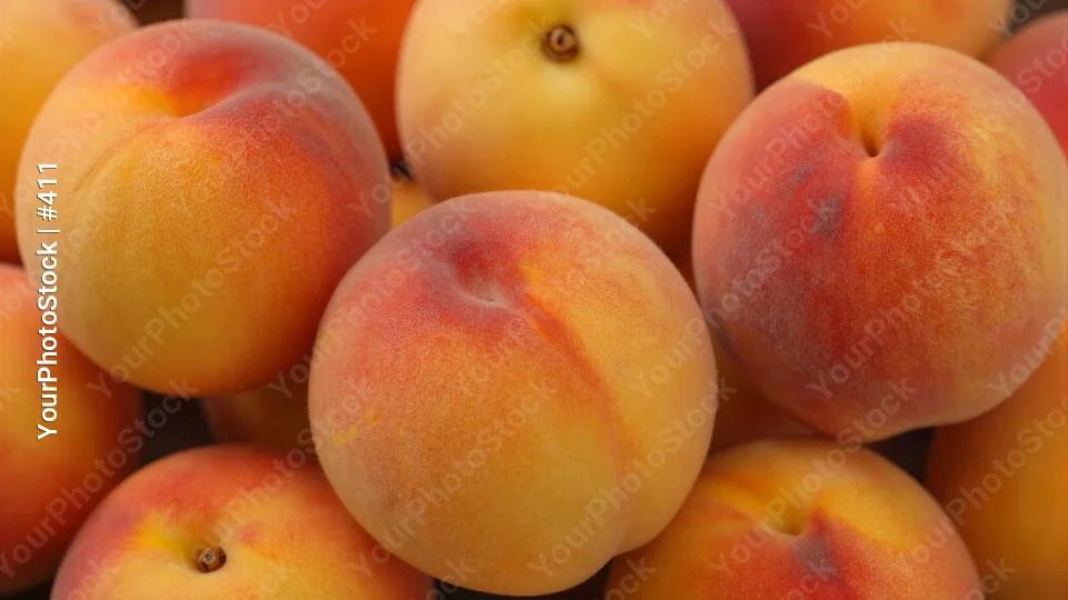 Close-Up of a Circular Arrangement of Yellow and Red Peaches