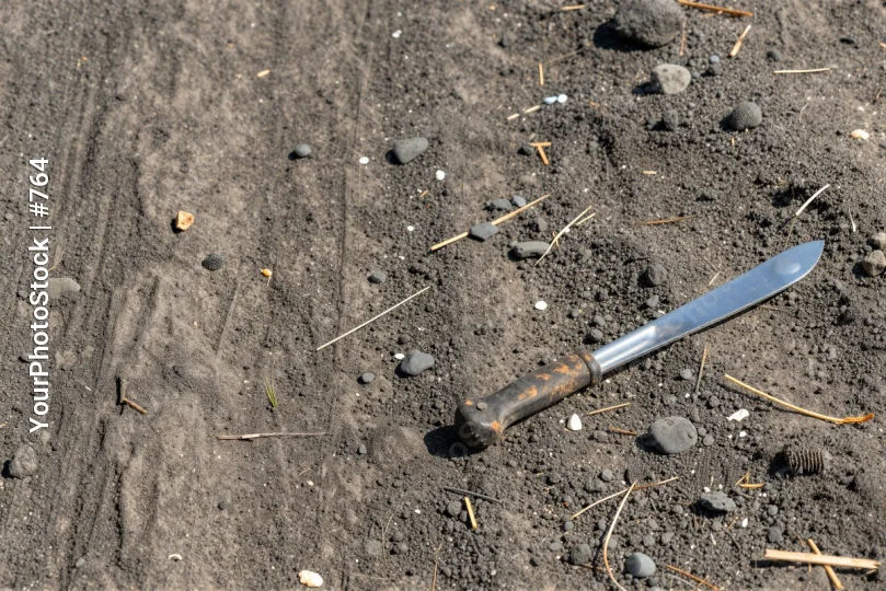 Rusty Knife on Rocks blade pebbles dirt gravel