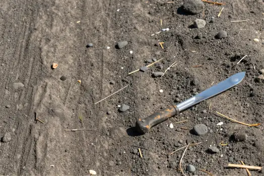 Rusty Knife on Rocks blade pebbles dirt gravel