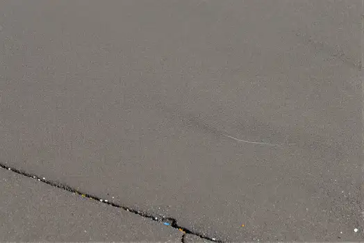 Close-up of Gray Surface with Textured Black Line and Blue Dot concrete
