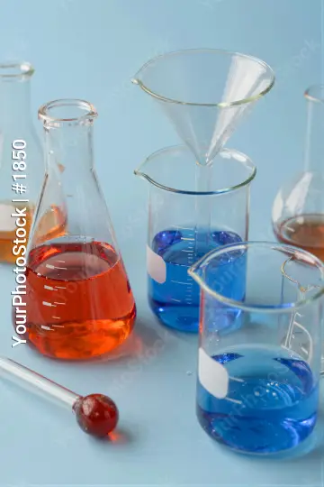 Group of laboratory glassware on light blue background