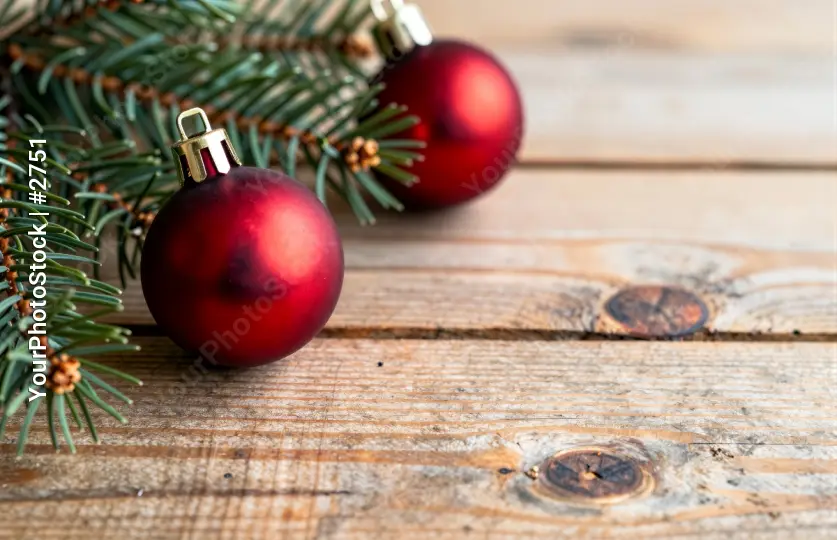 Rustic Christmas Decor with Pine Branches and Ornaments on Wood Background
