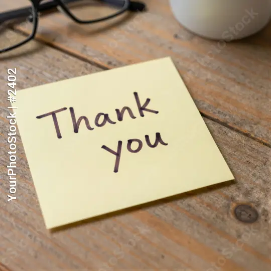 thank you sticky note on desk cursive wooden desk