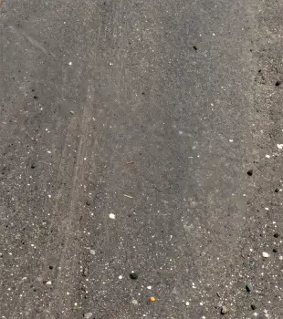 Wet Concrete Surface with Pebbles and Diagonal Line