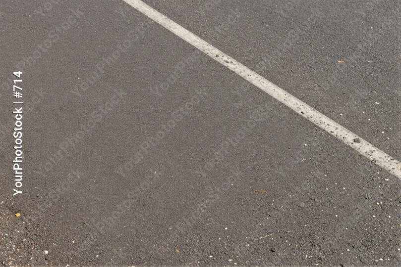 Close-up of an asphalt road with a straight white line