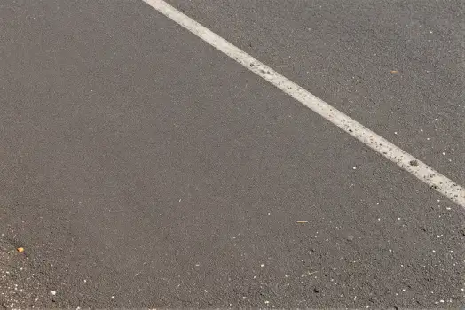 Close-up of an asphalt road with a straight white line