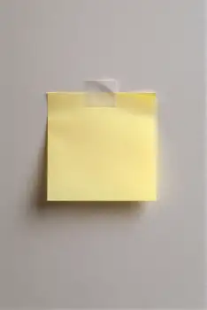 Minimalist Yellow Sticky Note on Gray Wall office