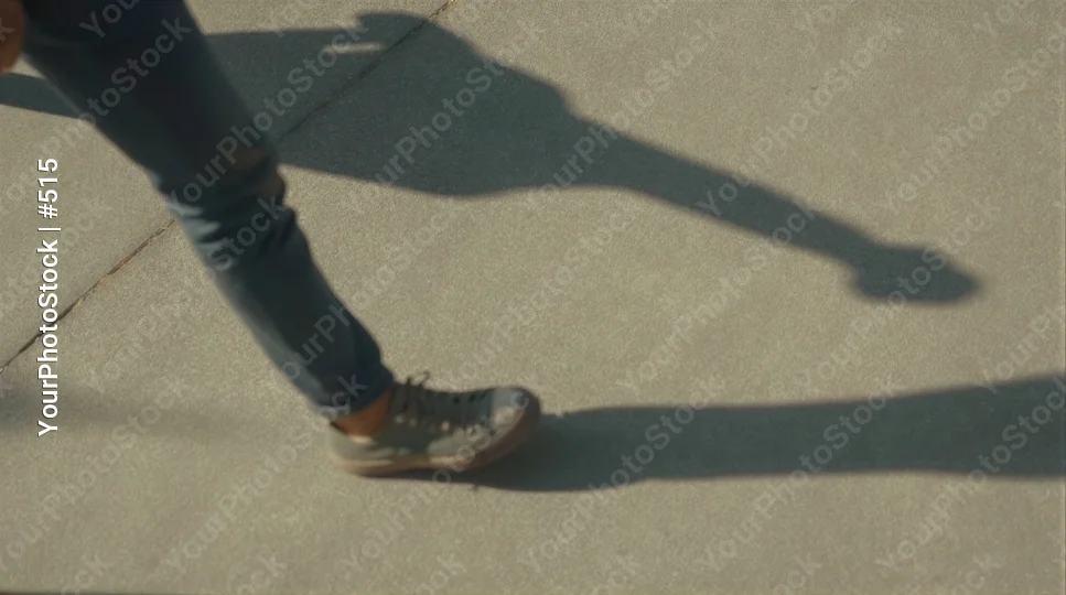 Person Walking on Concrete Path concrete surface