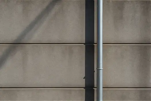 Metal Pole Against Beige Wall texture horizontal lines