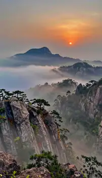 Mountain Range at Sunrise with Fog landscape orange sky