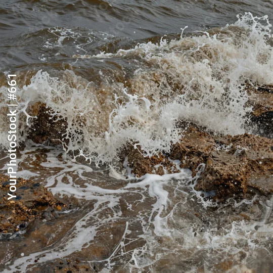 Rocky Shore Waves Crashing dark brown water pebbles