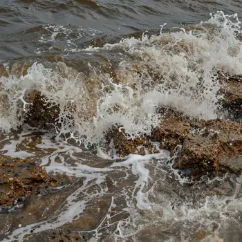 Rocky Shore Waves Crashing dark brown water pebbles