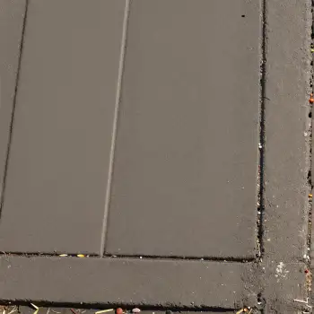 Close-up of Diagonal Gray Tiled Floor with Debris