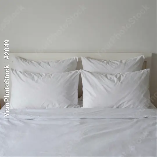 White Bed with Neatly Made Sheets and Pillows hotel