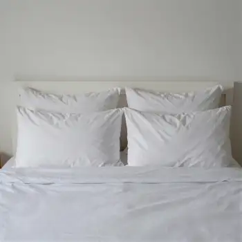 White Bed with Neatly Made Sheets and Pillows hotel