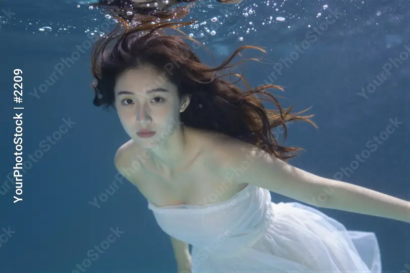 Young Woman Underwater in White Dress underwater portrait