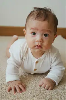 Baby Crawling Curiously on Carpet portrait floor