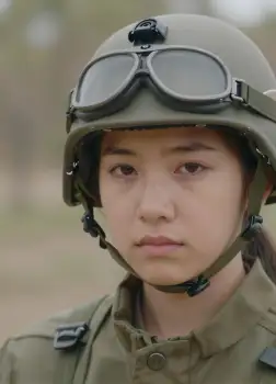 Young Woman in Green Military Uniform with Helmet and Goggles