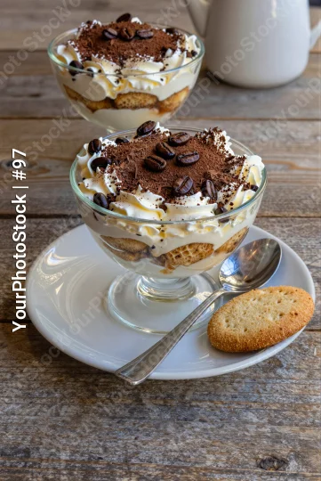 Two Glass Trifles with Whipped Cream and Chocolate Shavings on Rustic dessert