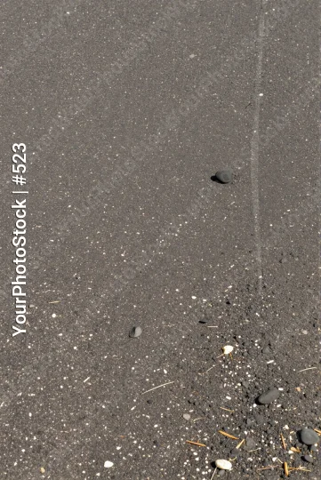 Wet Asphalt Surface with Debris Close-Up construction
