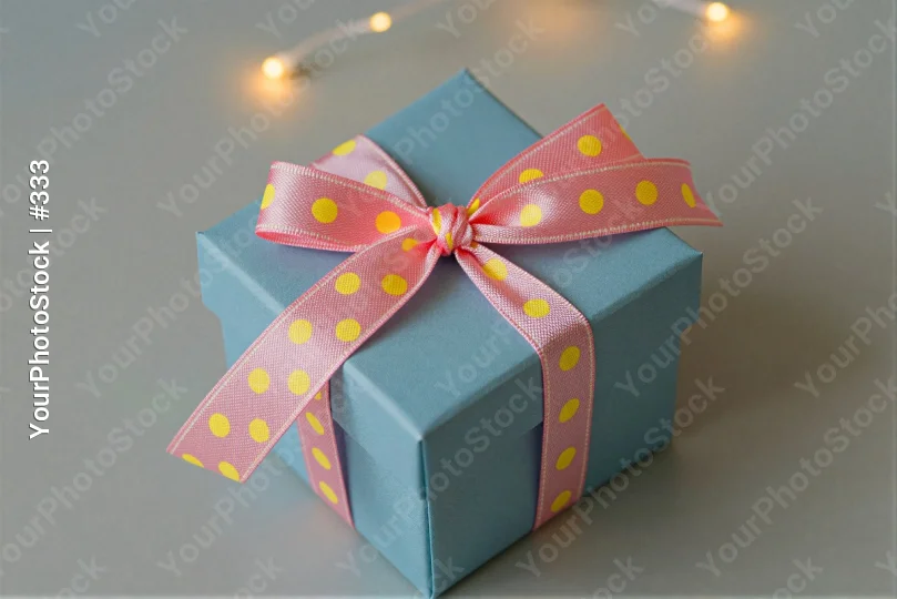 Blue Gift Box with Polka Dot Ribbon bow pink white surface