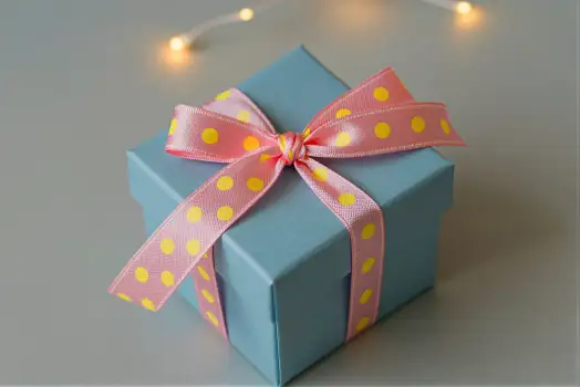 Blue Gift Box with Polka Dot Ribbon bow pink white surface