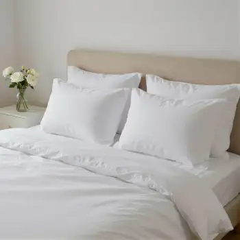 Bedroom with White Sheets and Pillows beige headboard hotel