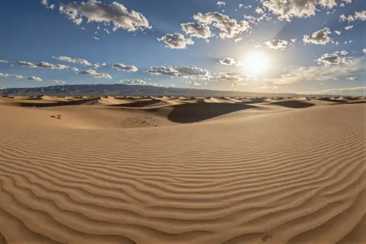 Desert Landscape with Clear Blue Sky and Sunlit Sand Dunes